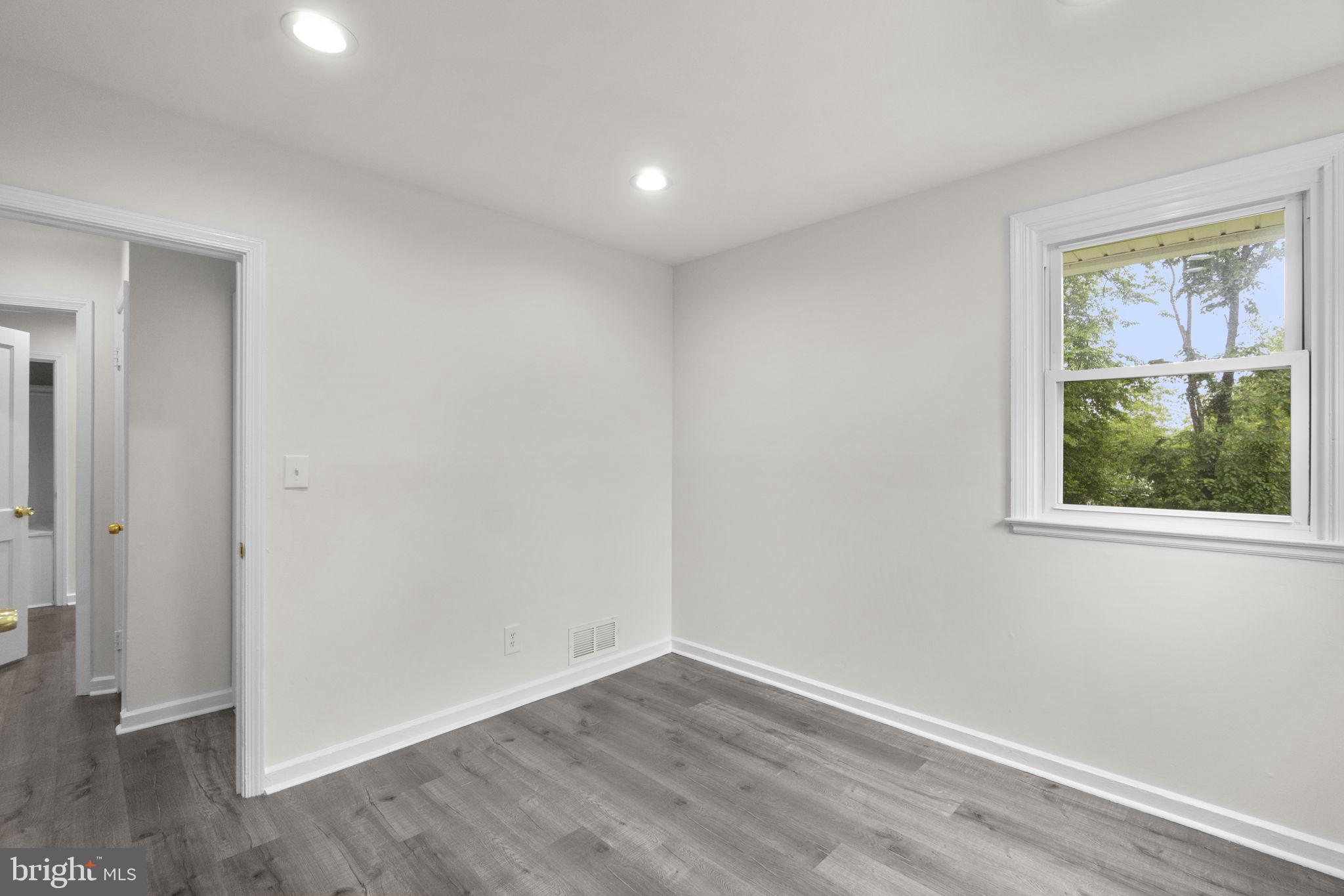3658 Clifmar Road Baltimore, MD 21244 - Photo 26 of 43 an empty room with wooden floor and a window