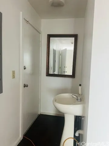 a bathroom with a toilet a sink and mirror