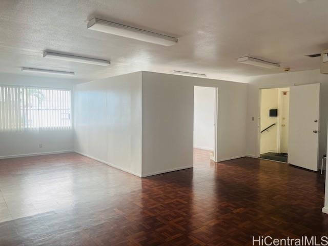 1728 Dillingham Boulevard, Unit B Honolulu, HI 96819 - Photo 8 of 15 an empty room with wooden floor and windows