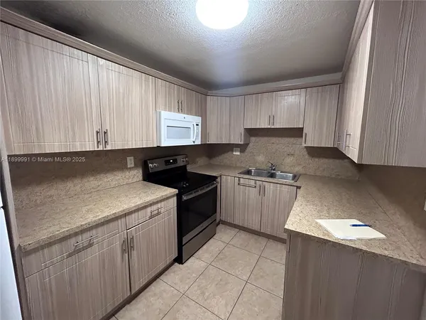 a kitchen with a sink stove and cabinets