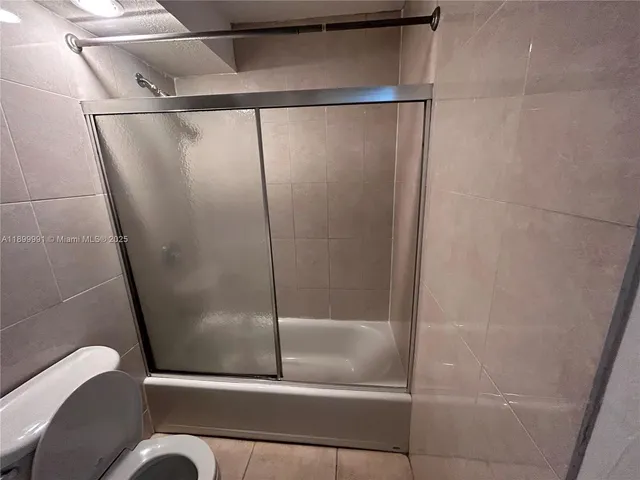 a bathroom with a glass shower door