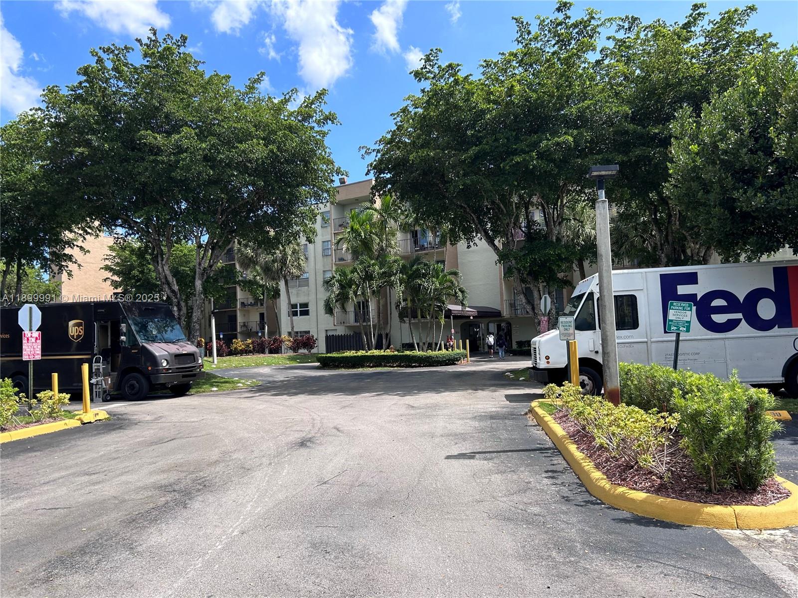 14250 Southwest 62nd Street, Unit 302 Miami, FL 33183 - Photo 8 of 8 a view of a street with large trees