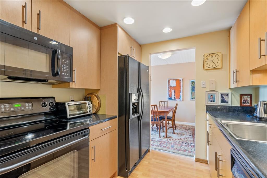 5600 Munhall Road, Unit 816 Pittsburgh, PA 15217 - Photo 11 of 20 a kitchen with stainless steel appliances granite countertop a refrigerator stove and sink