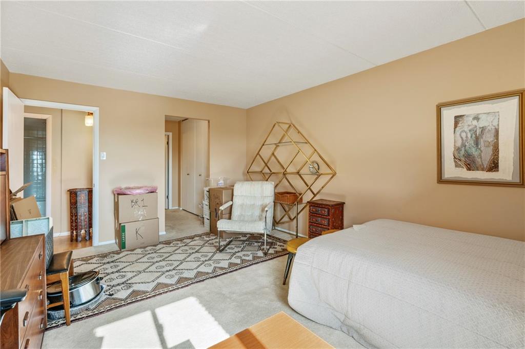 5600 Munhall Road, Unit 816 Pittsburgh, PA 15217 - Photo 15 of 20 a bedroom with a bed and a chandelier