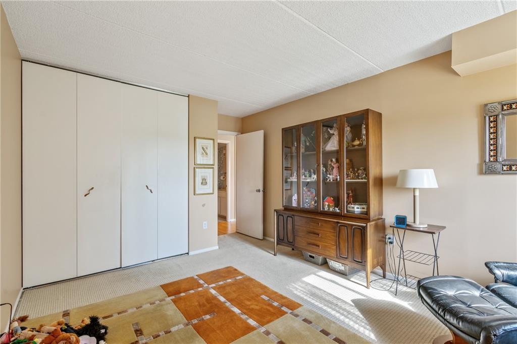 5600 Munhall Road, Unit 816 Pittsburgh, PA 15217 - Photo 16 of 20 a bedroom with a bed and a lamp on table