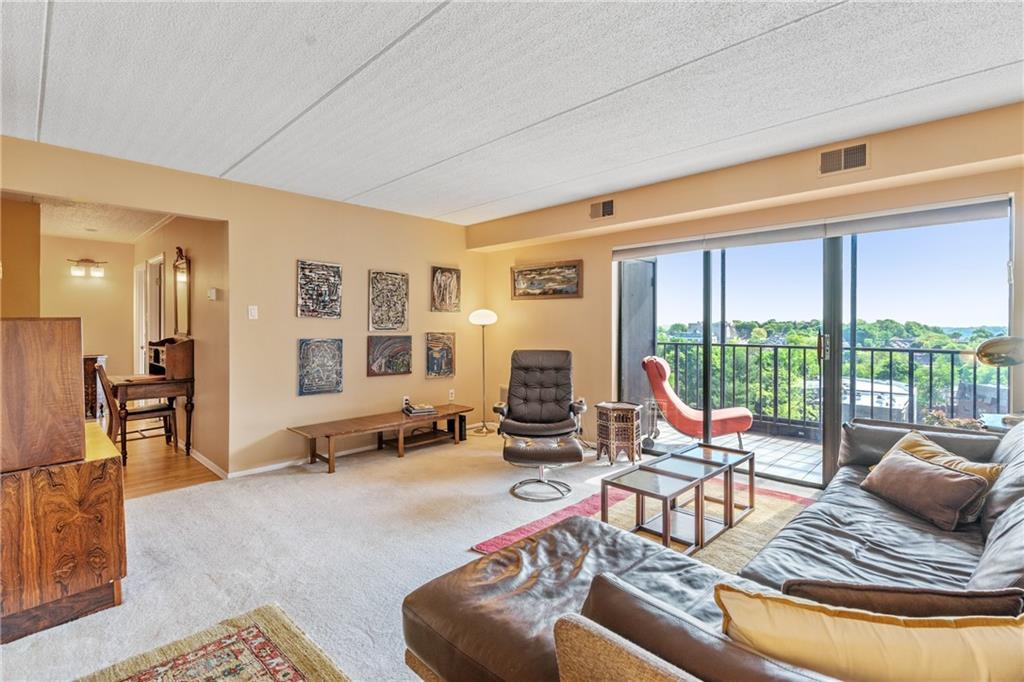 5600 Munhall Road, Unit 816 Pittsburgh, PA 15217 - Photo 5 of 20 a living room with furniture and floor to ceiling windows