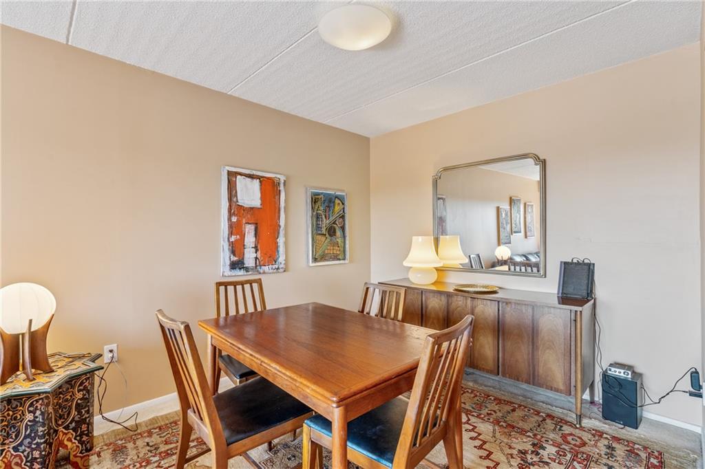 5600 Munhall Road, Unit 816 Pittsburgh, PA 15217 - Photo 8 of 20 a view of a dining room with furniture and a chandelier