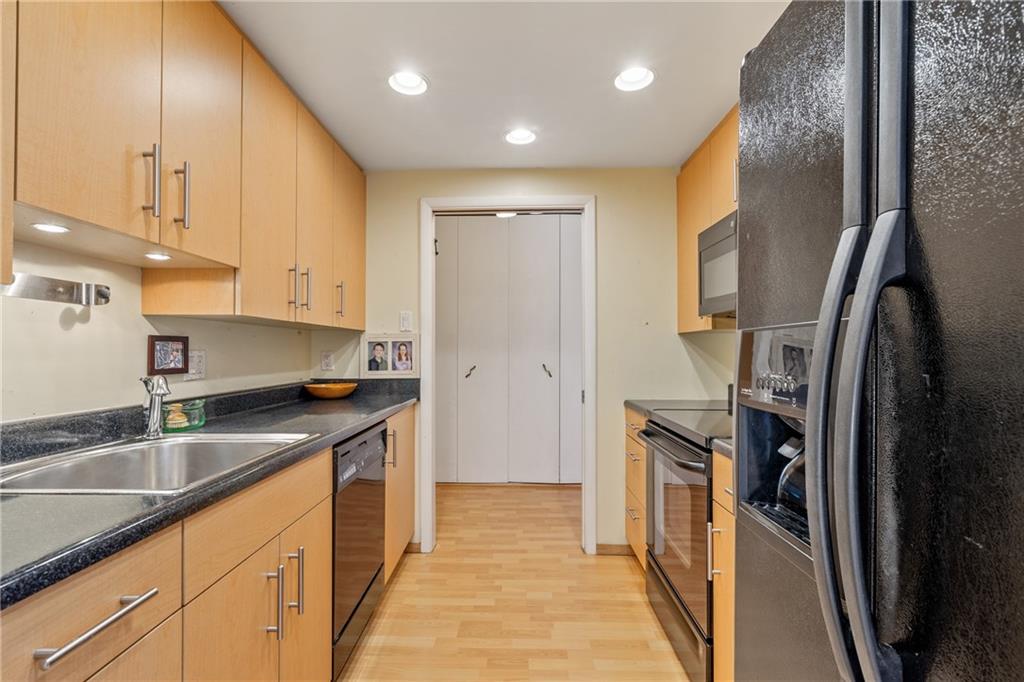 5600 Munhall Road, Unit 816 Pittsburgh, PA 15217 - Photo 9 of 20 a kitchen with stainless steel appliances granite countertop a sink a stove and a refrigerator