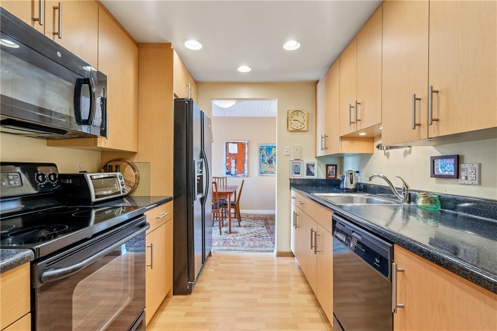 5600 Munhall Road, Unit 816 Pittsburgh, PA 15217 - Photo 10 of 20 a kitchen with stainless steel appliances granite countertop a sink a stove and cabinets