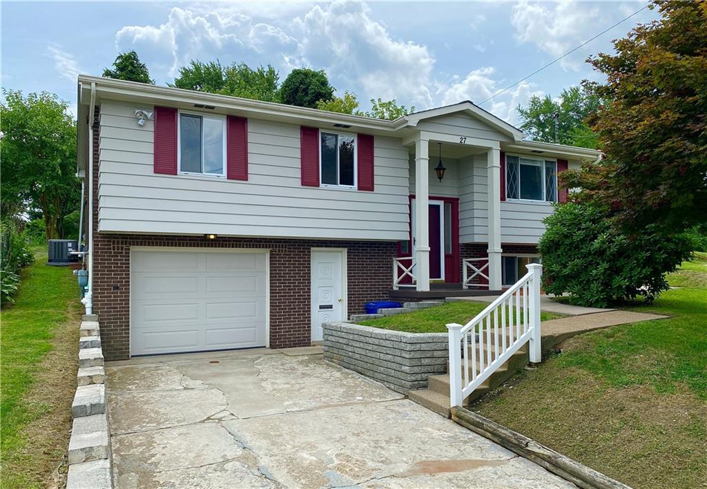 a front view of house with deck and yard