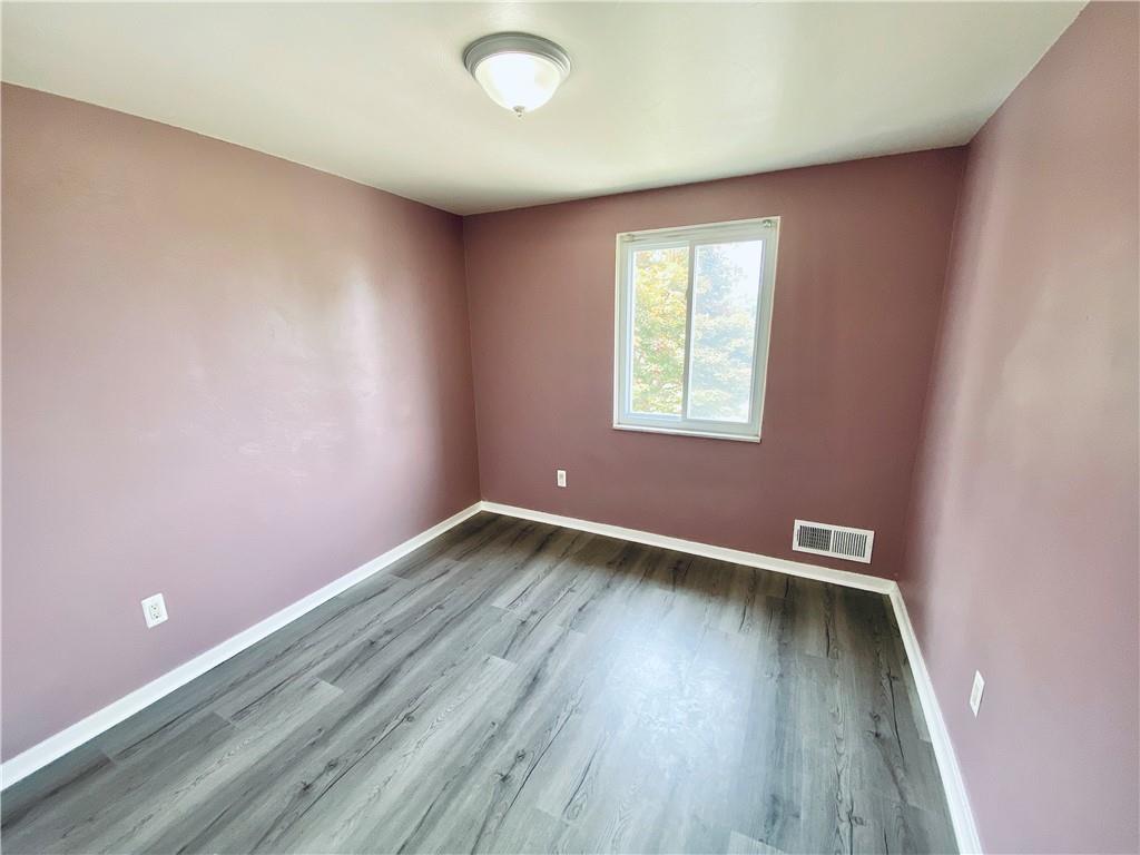 27 Flora Road Pittsburgh, PA 15227 - Photo 11 of 19 an empty room with wooden floor and windows
