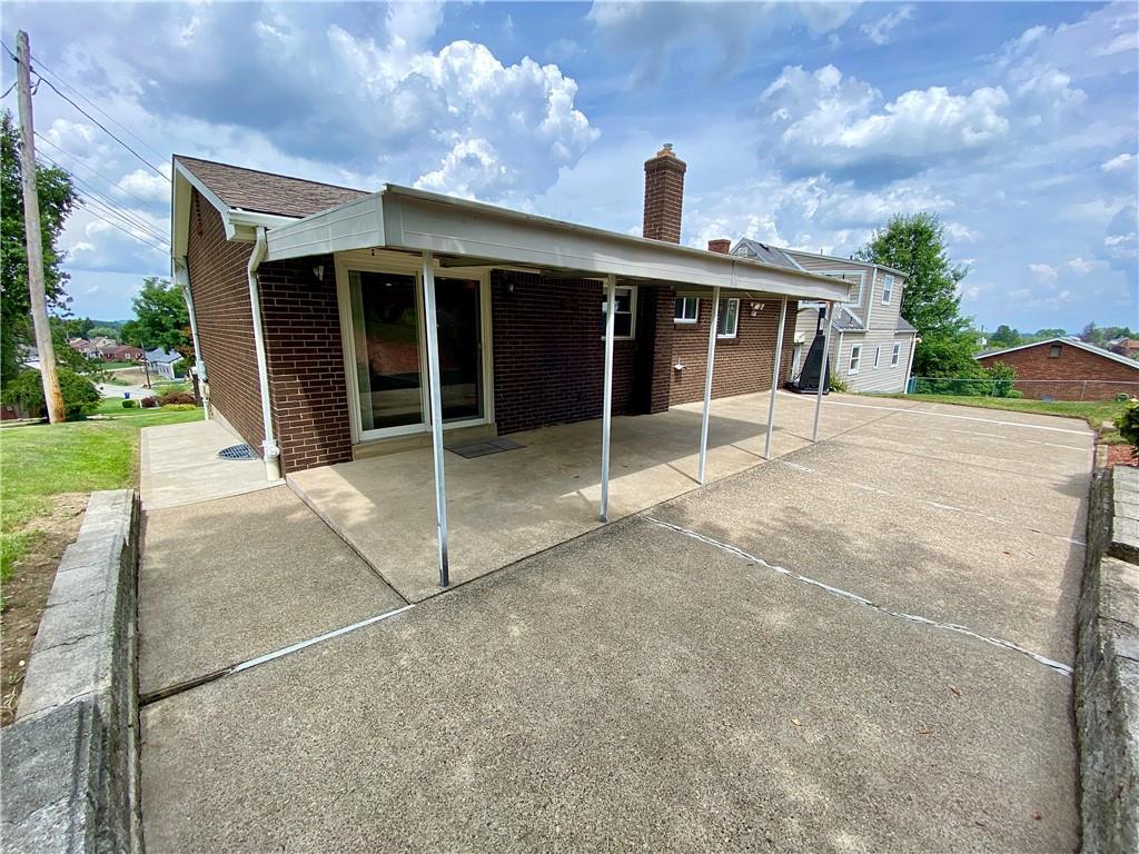 27 Flora Road Pittsburgh, PA 15227 - Photo 16 of 19 a view of a house with a large window and a yard