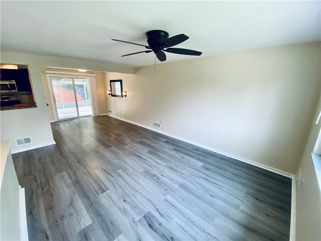 27 Flora Road Pittsburgh, PA 15227 - Photo 3 of 19 a view of empty room with wooden floor and fan