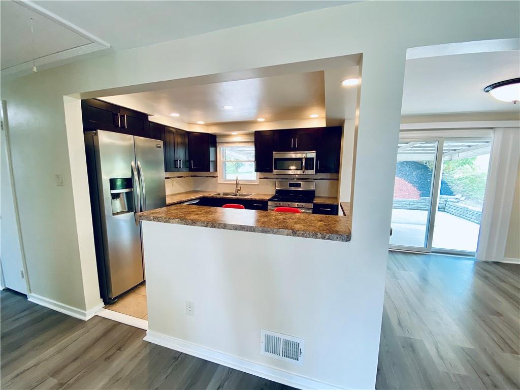 27 Flora Road Pittsburgh, PA 15227 - Photo 5 of 19 a kitchen with stainless steel appliances a refrigerator and a stove top oven