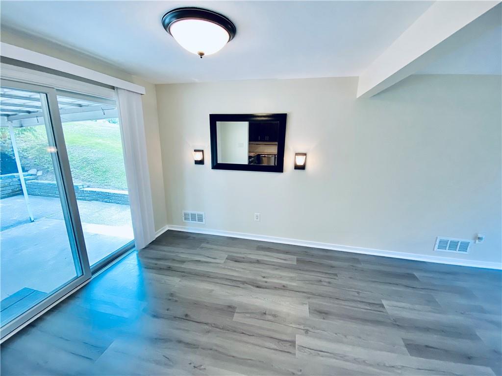 27 Flora Road Pittsburgh, PA 15227 - Photo 6 of 19 a view of an empty room with wooden floor and a window