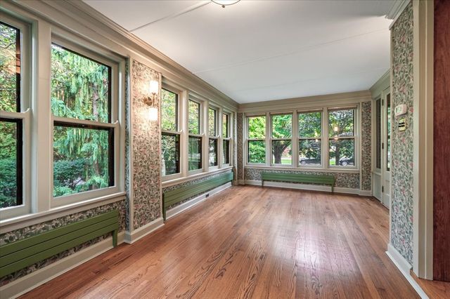 a view of hallway with wooden floor and doors