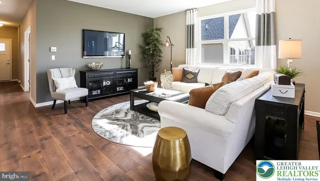 a living room with furniture flowerpot and a window