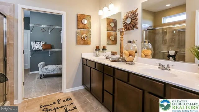 a en suite bathroom with a sink a mirror and a shower