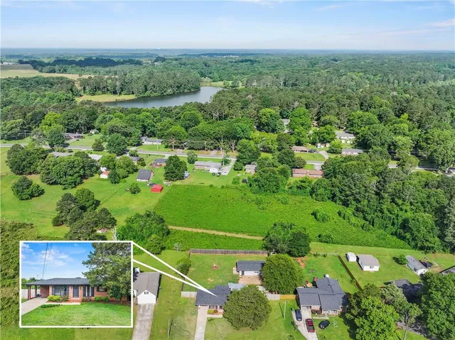 an aerial view of a houses with a yard