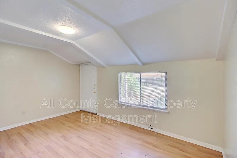 3800 Allegro Lugar Street, Unit 3B Austin, TX 78749 - Photo 5 of 11 an empty room with wooden floor and windows
