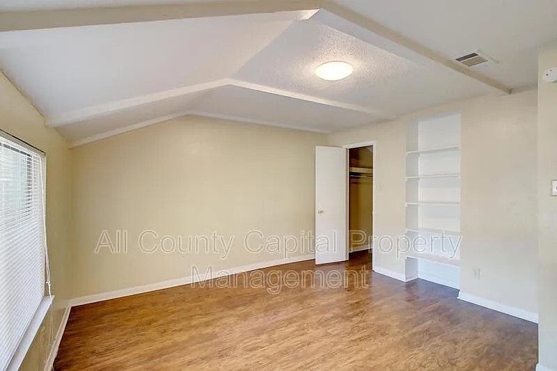 3800 Allegro Lugar Street, Unit 3B Austin, TX 78749 - Photo 7 of 11 an empty room with closet and wooden floor