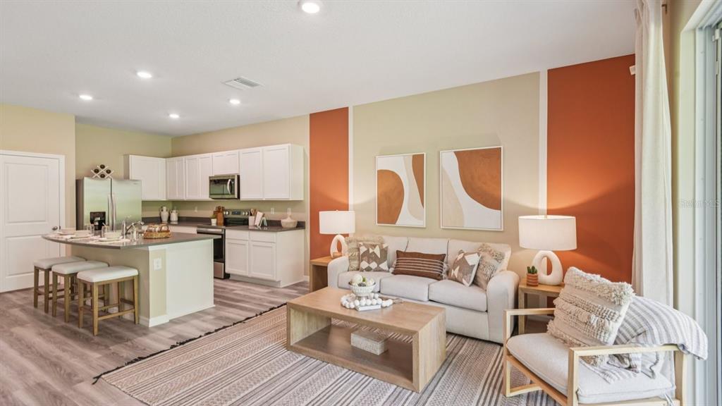 32471 Welling Blade Loop Wesley Chapel, FL 33545 - Photo 7 of 42 a living room with furniture and kitchen view