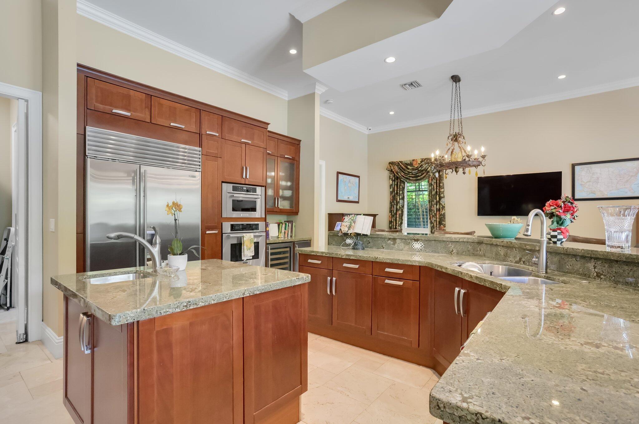 2409 Northeast 12th Street Fort Lauderdale, FL 33304 - Photo 15 of 65 a kitchen with stainless steel appliances granite countertop a sink counter space cabinets and living room view