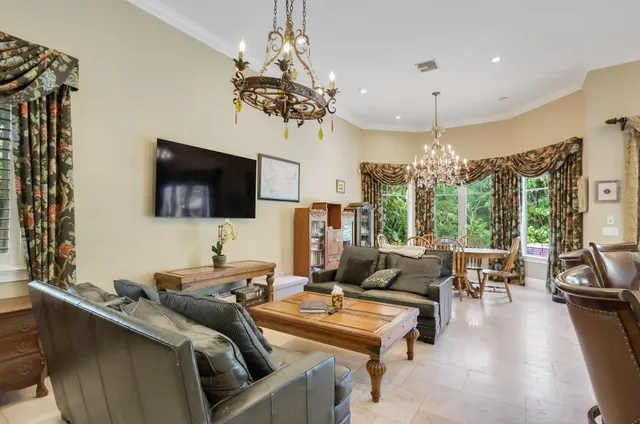 a living room with furniture or window and a dining table with wooden floor