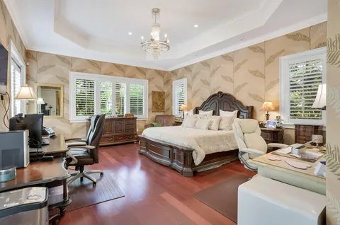 a bedroom with a bed and a chair in it