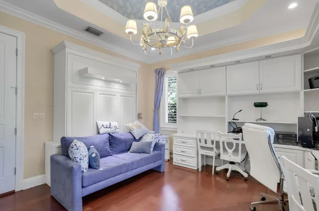 a bedroom with a bed and a ceiling fan