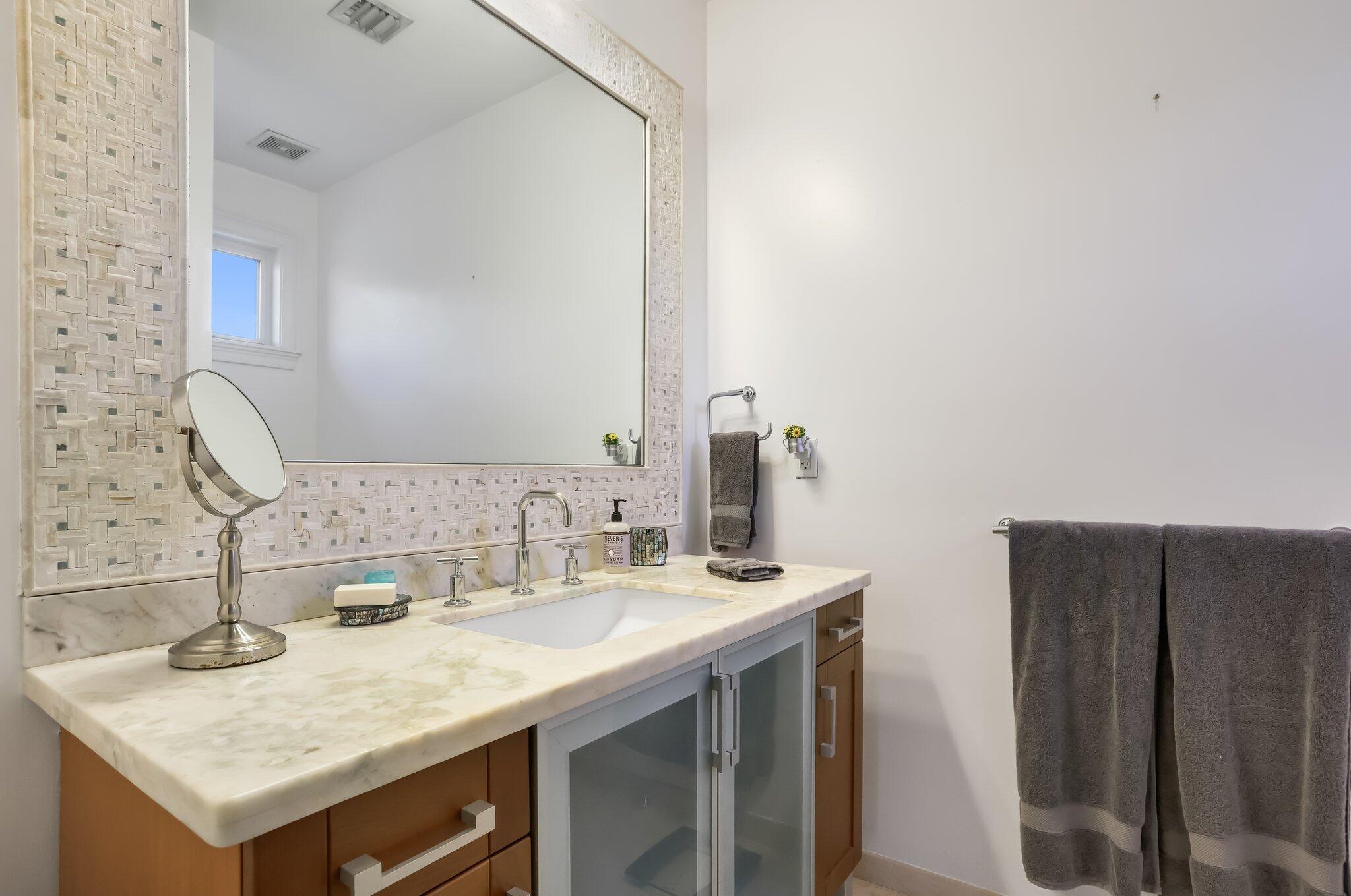 2409 Northeast 12th Street Fort Lauderdale, FL 33304 - Photo 36 of 65 a bathroom with a sink and a mirror