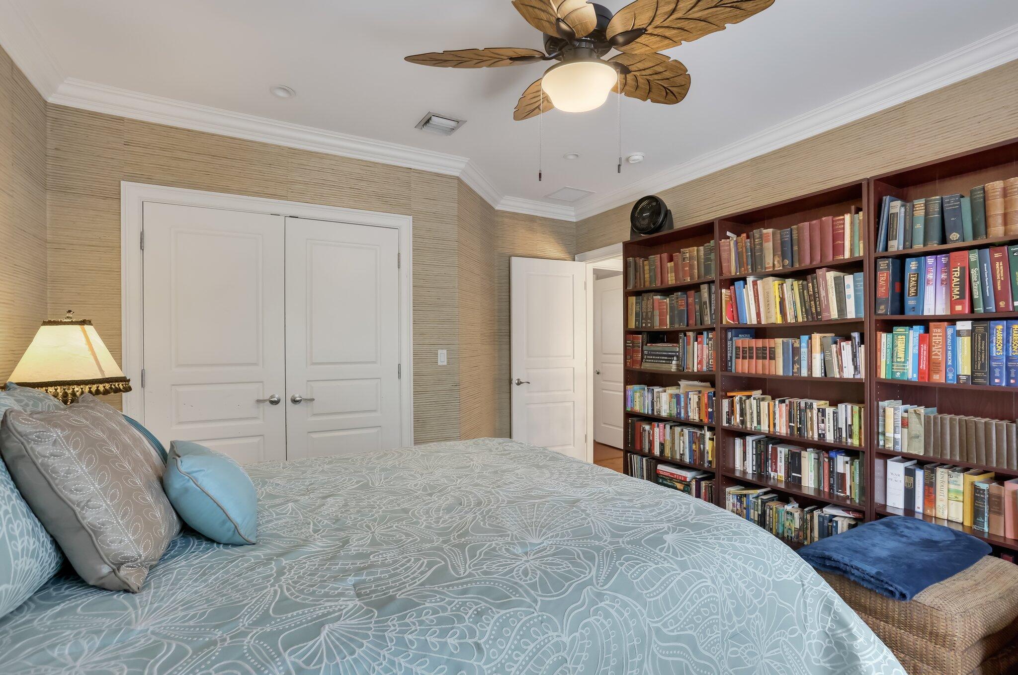 2409 Northeast 12th Street Fort Lauderdale, FL 33304 - Photo 44 of 65 a spacious bedroom with a bed and a book shelf