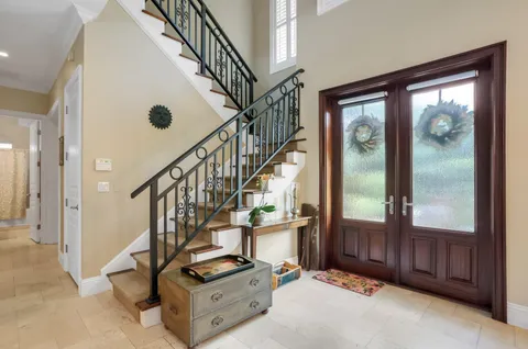a dining hall with stainless steel appliances a dining table and chairs