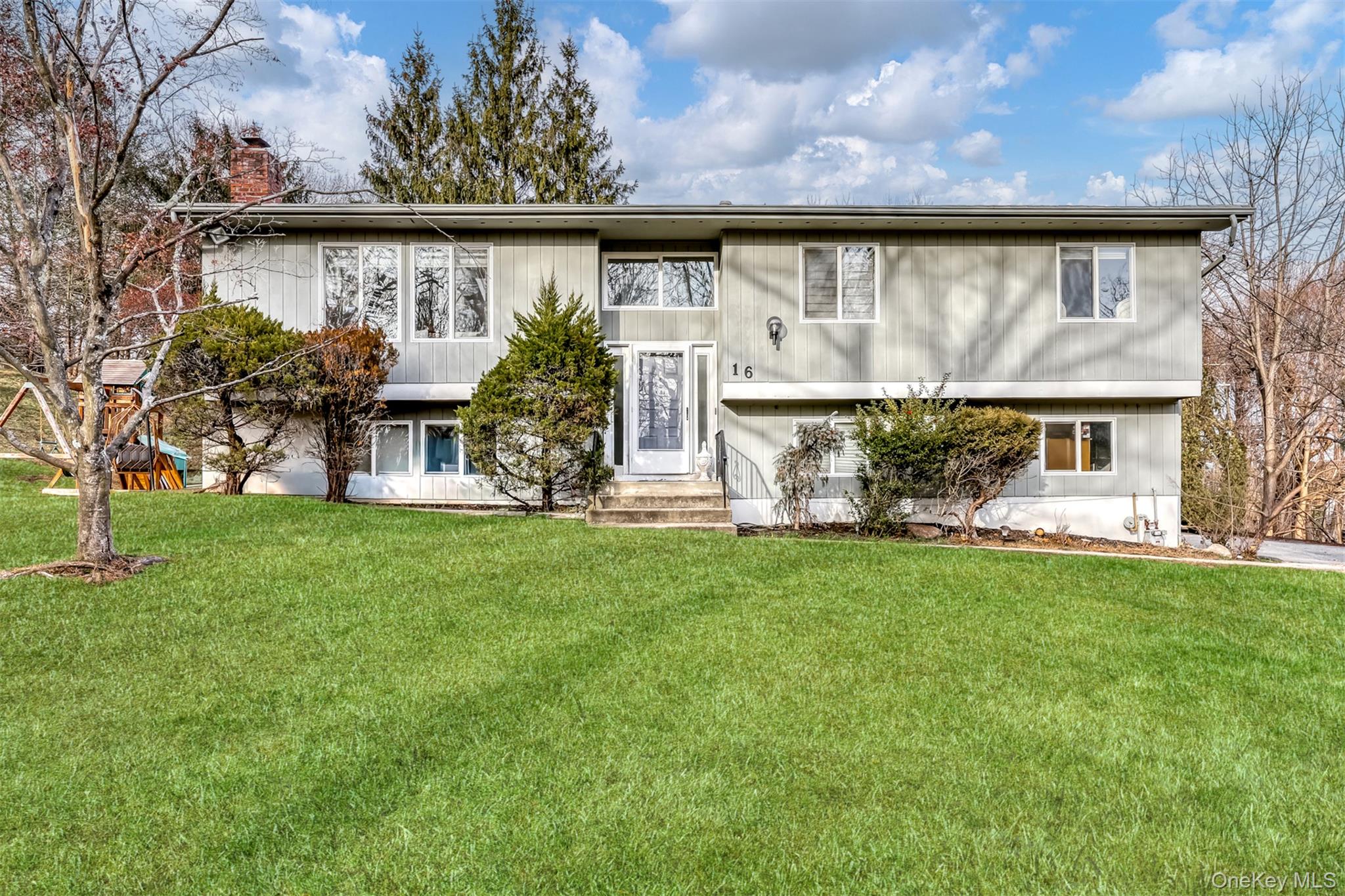 View of front of property with a front yard and a chimney
