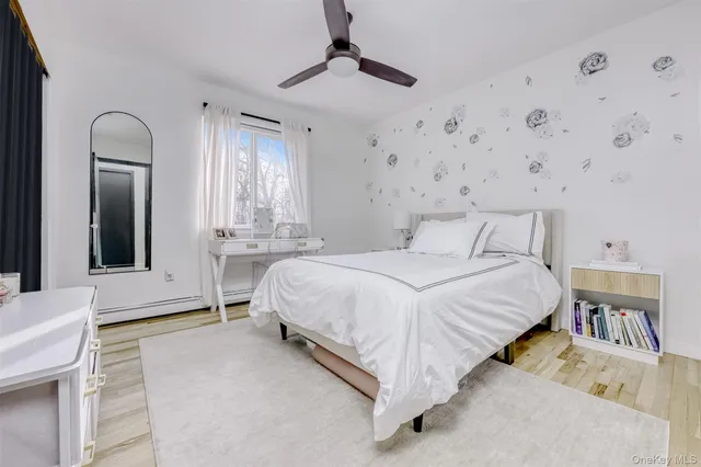 a spacious bedroom with a bed and a chandelier