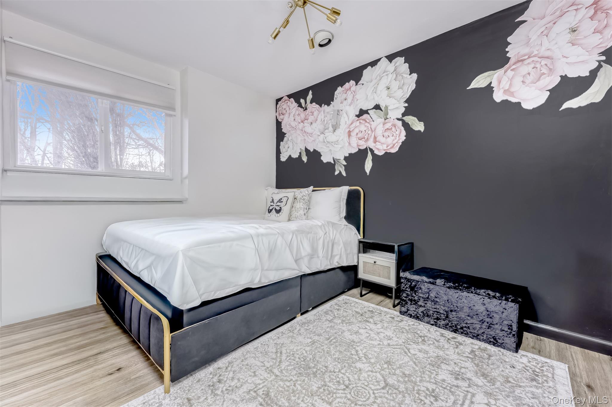 16 Old Pomona Road Suffern, NY 10901 - Photo 15 of 22 a bedroom with a bed and a chandelier