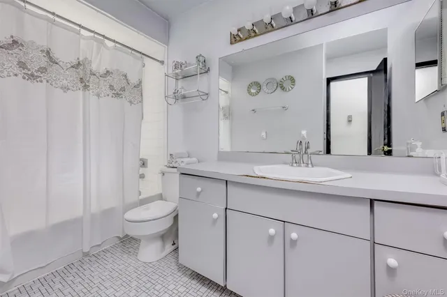 a bathroom with a sink toilet a mirror and shower