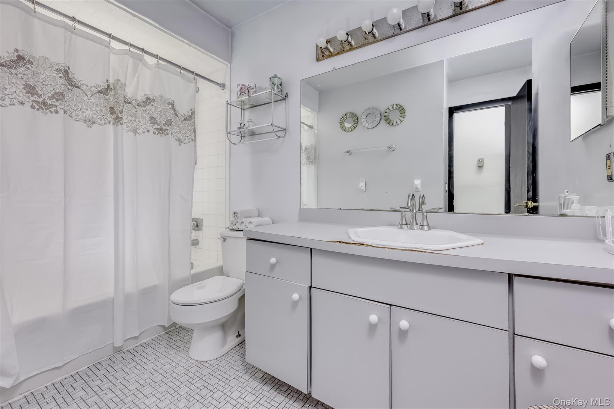 16 Old Pomona Road Suffern, NY 10901 - Photo 16 of 22 a bathroom with a sink toilet a mirror and shower