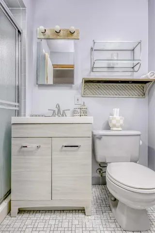a bathroom with a sink a toilet and vanity