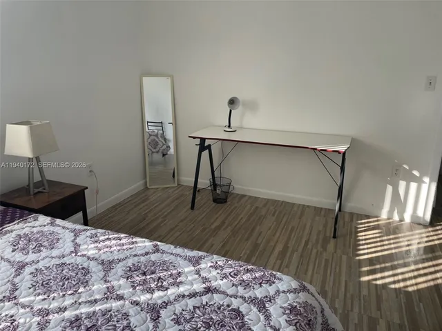a bedroom with a bed and a table in it
