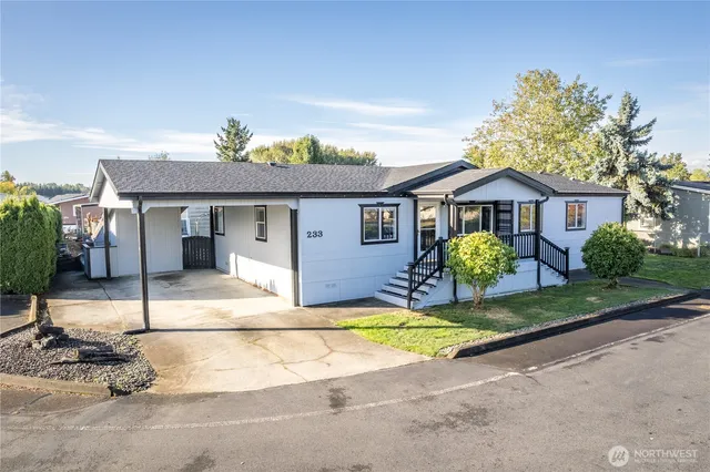 a view of a house with a swimming pool and a yard