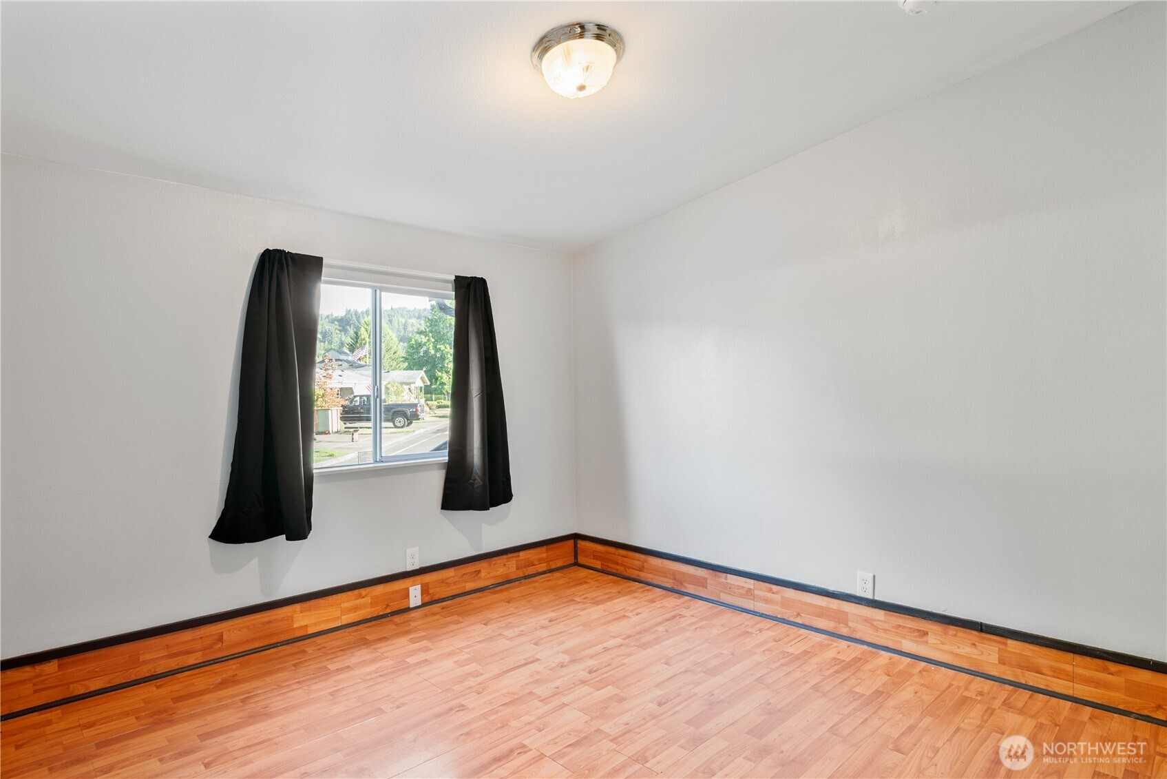 233 Concord Place Longview, WA 98632 - Photo 16 of 34 wooden floor in an empty room with a window