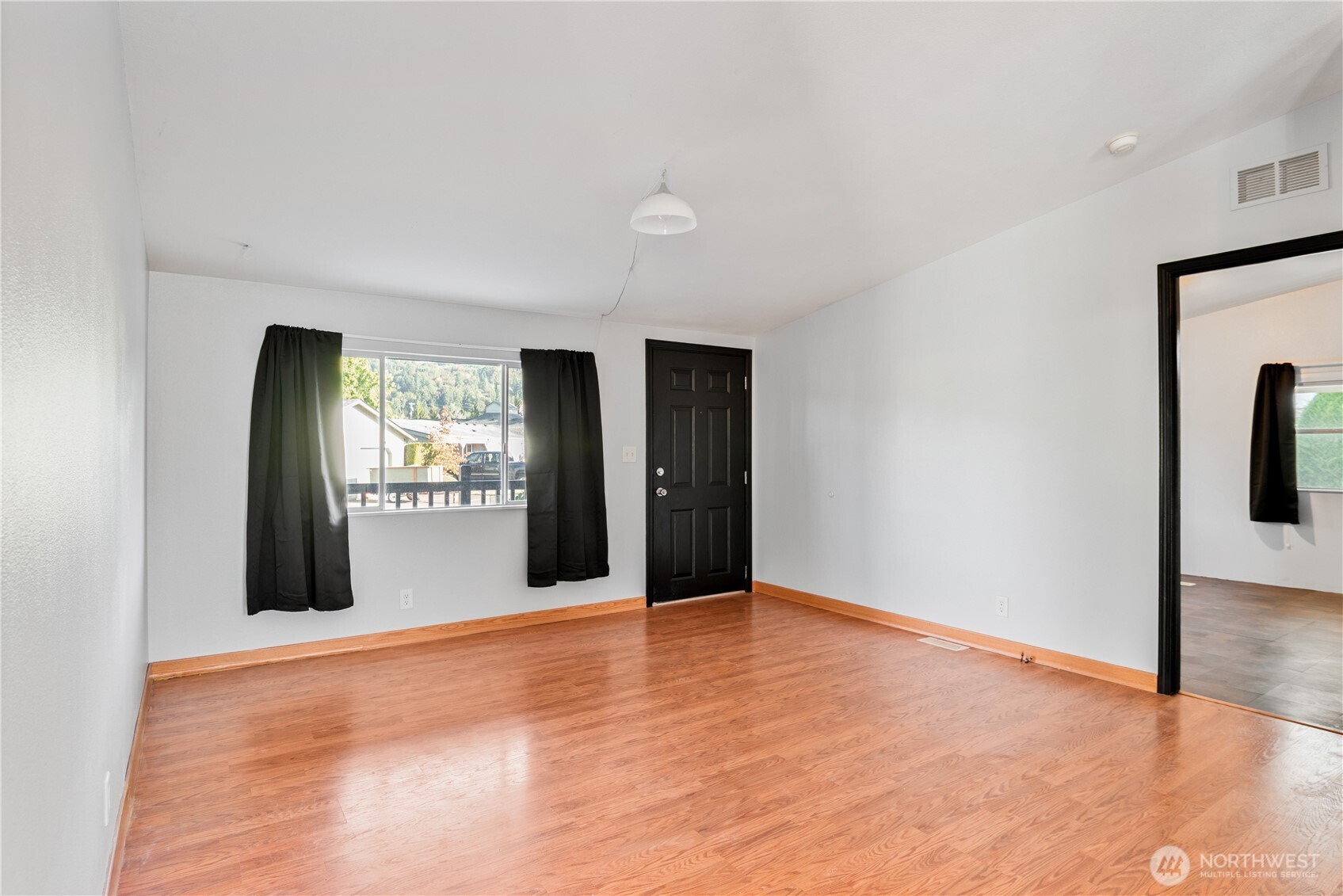 233 Concord Place Longview, WA 98632 - Photo 6 of 34 a view of an empty room with window and wooden floor