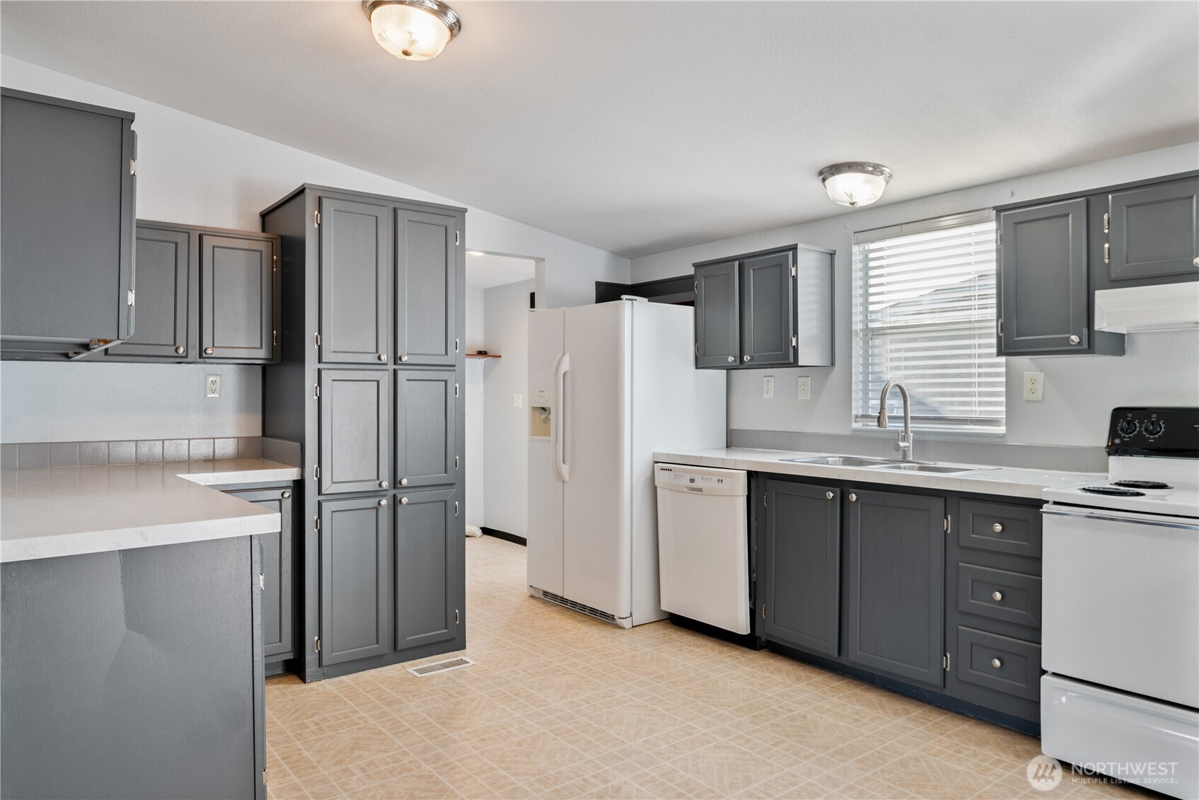 233 Concord Place Longview, WA 98632 - Photo 7 of 34 a kitchen with stainless steel appliances a refrigerator sink and cabinets