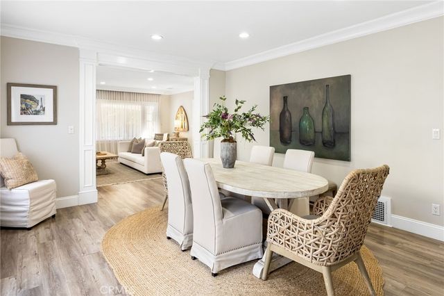 a dining room with furniture and wooden floor