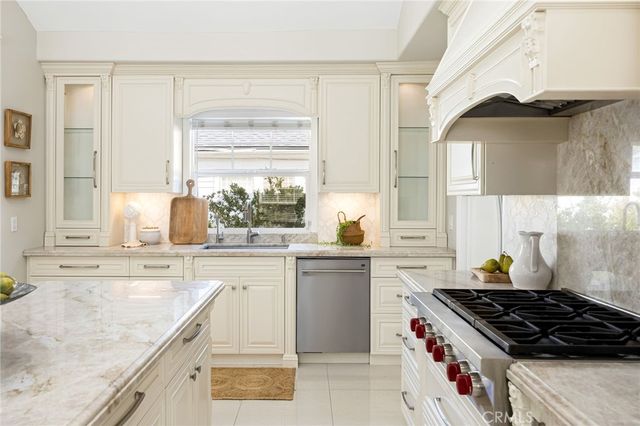 a kitchen with a stove a sink and a cabinets