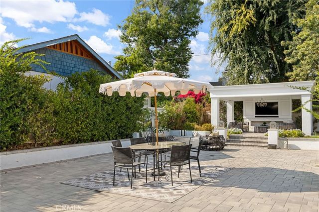 a view of a patio with table and chairs potted plants with wooden fence