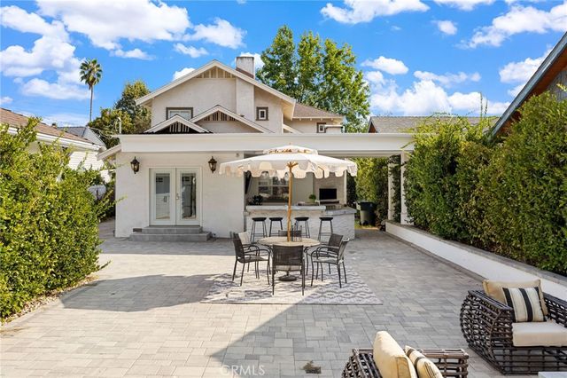 a view of a patio with table and chairs and potted plants