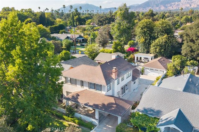 an aerial view of multiple houses with yard