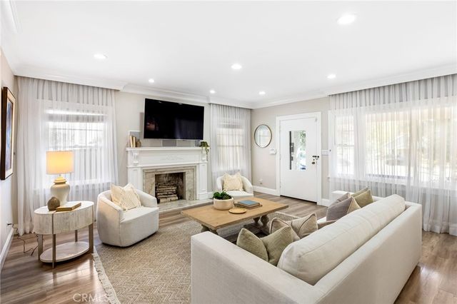 a living room with furniture a fireplace and a flat screen tv